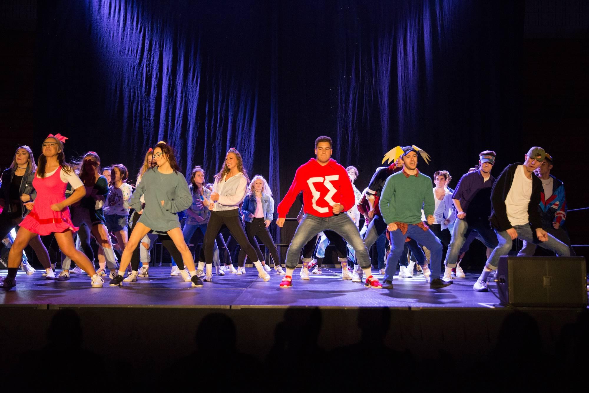 Greek life students dancing on stage at the lip syncing battle